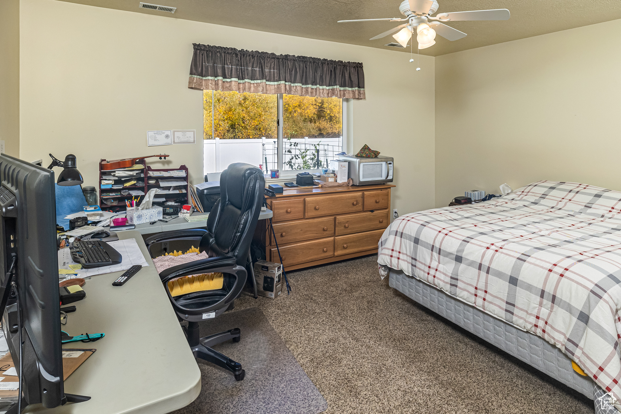 Carpeted bedroom with ceiling fan