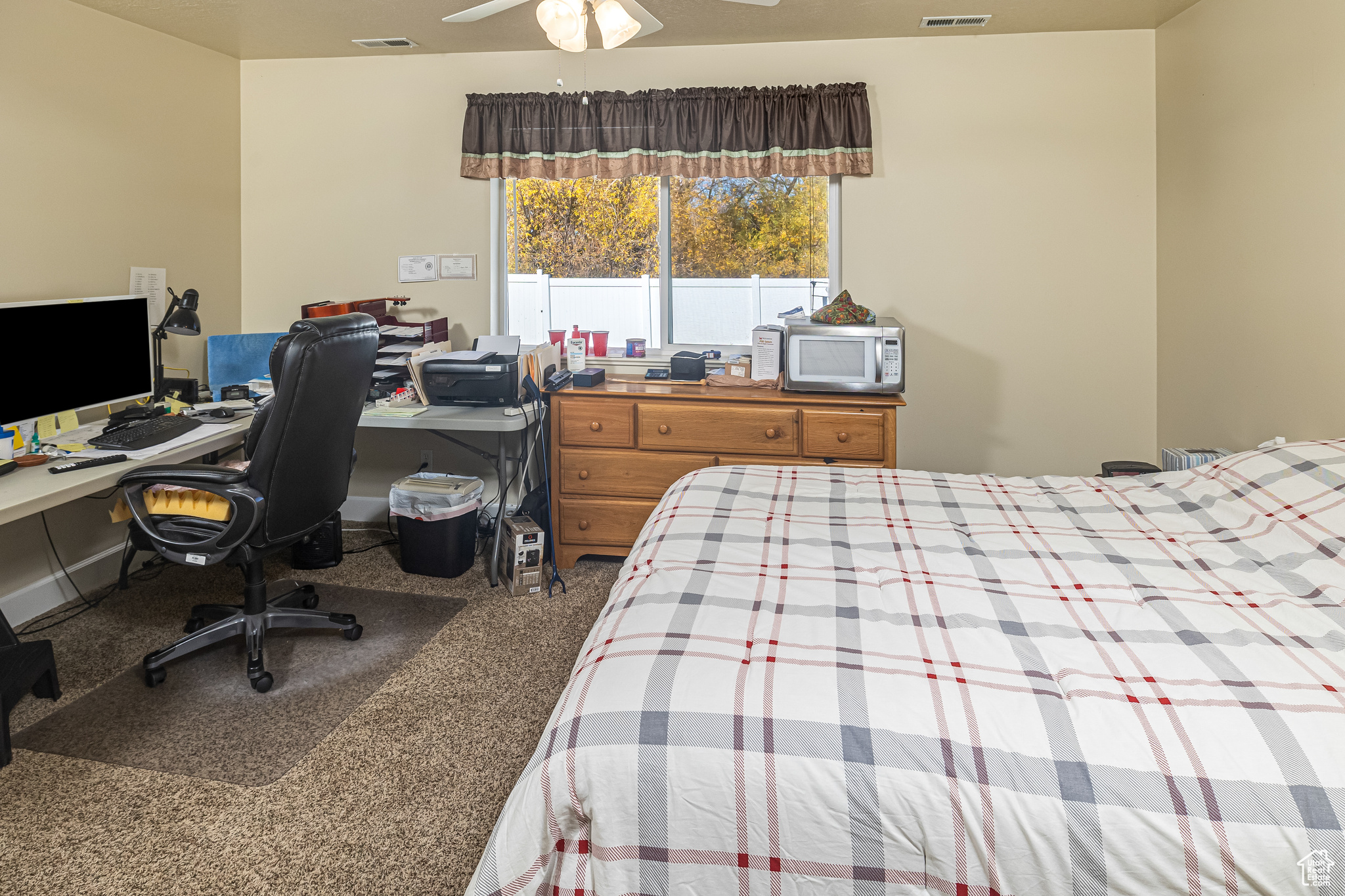 Carpeted bedroom with ceiling fan