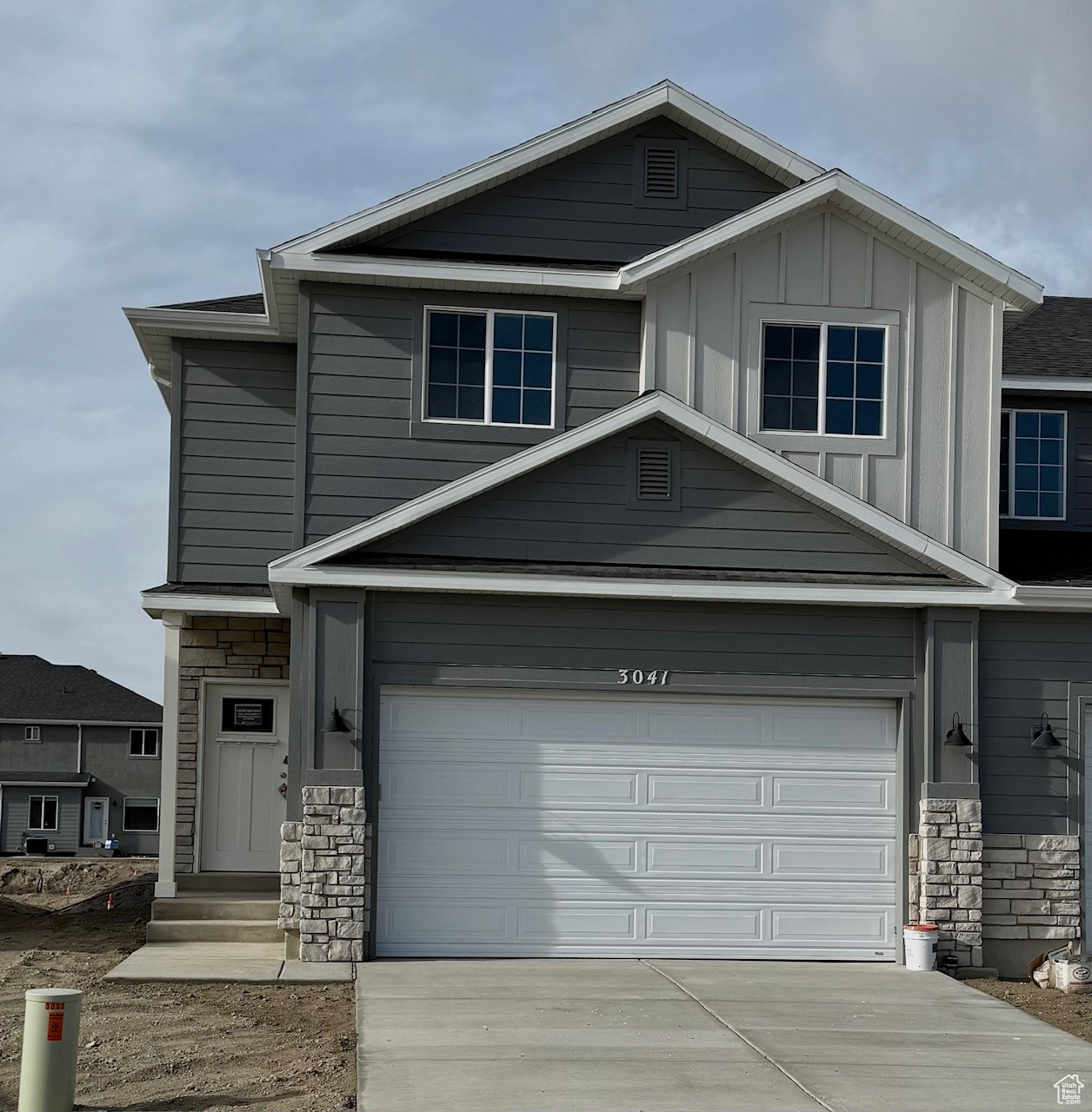 View of front facade featuring a garage