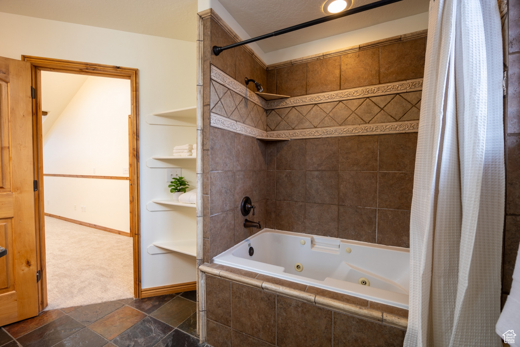 Bathroom with shower / bathtub combination with curtain