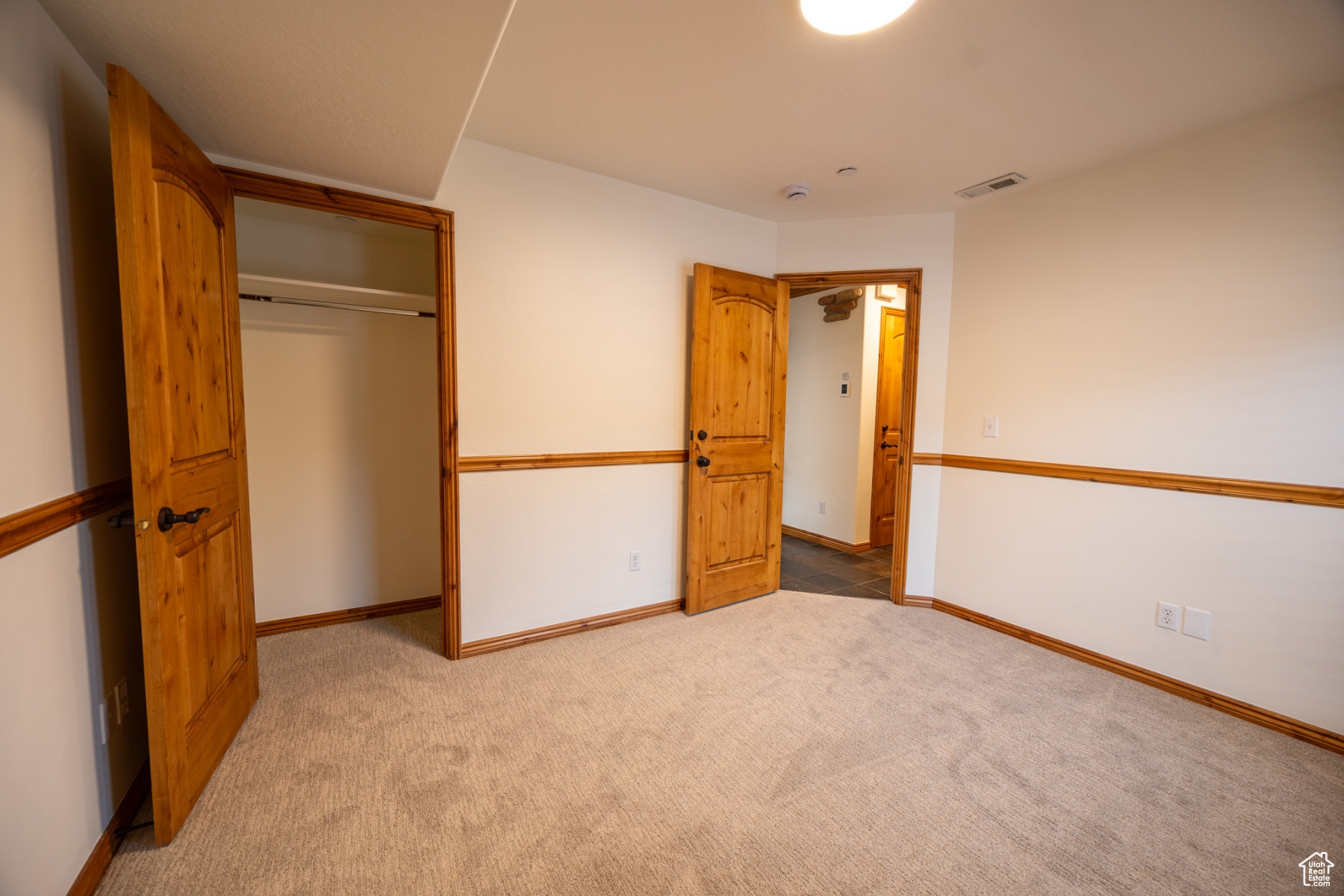 Unfurnished bedroom with a closet and carpet