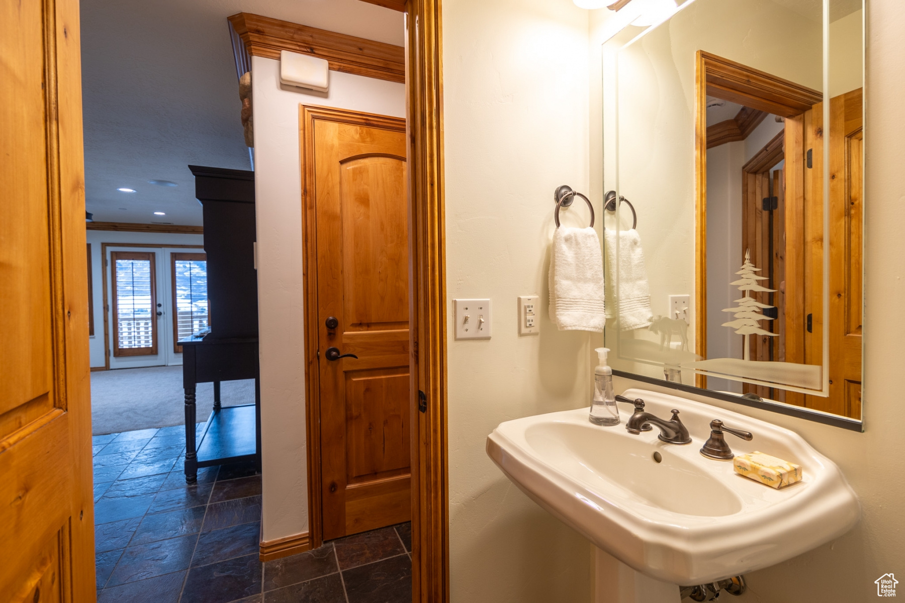 Bathroom with sink, french doors, and ornamental molding