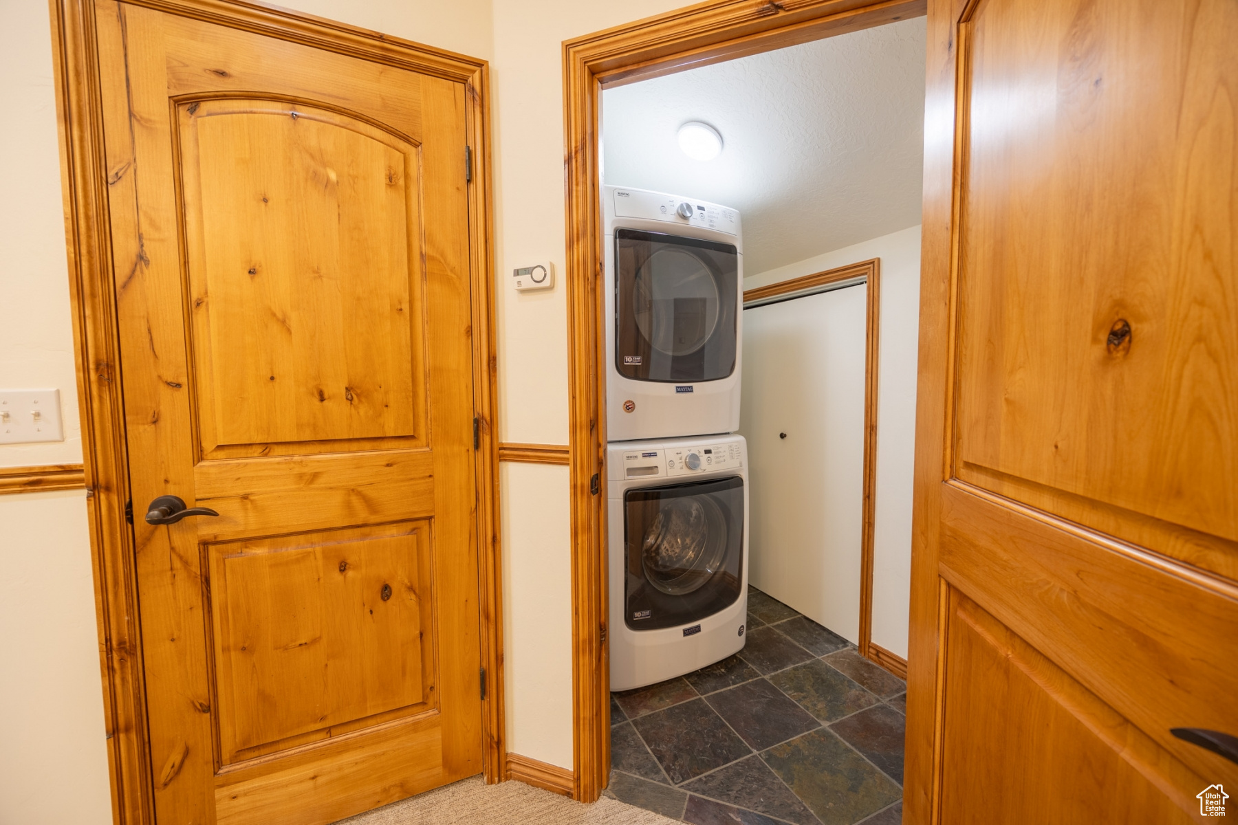 Laundry room featuring stacked washer and clothes dryer