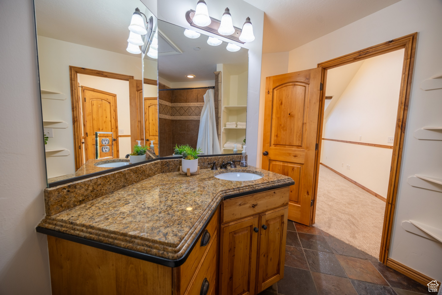 Bathroom with vanity and curtained shower