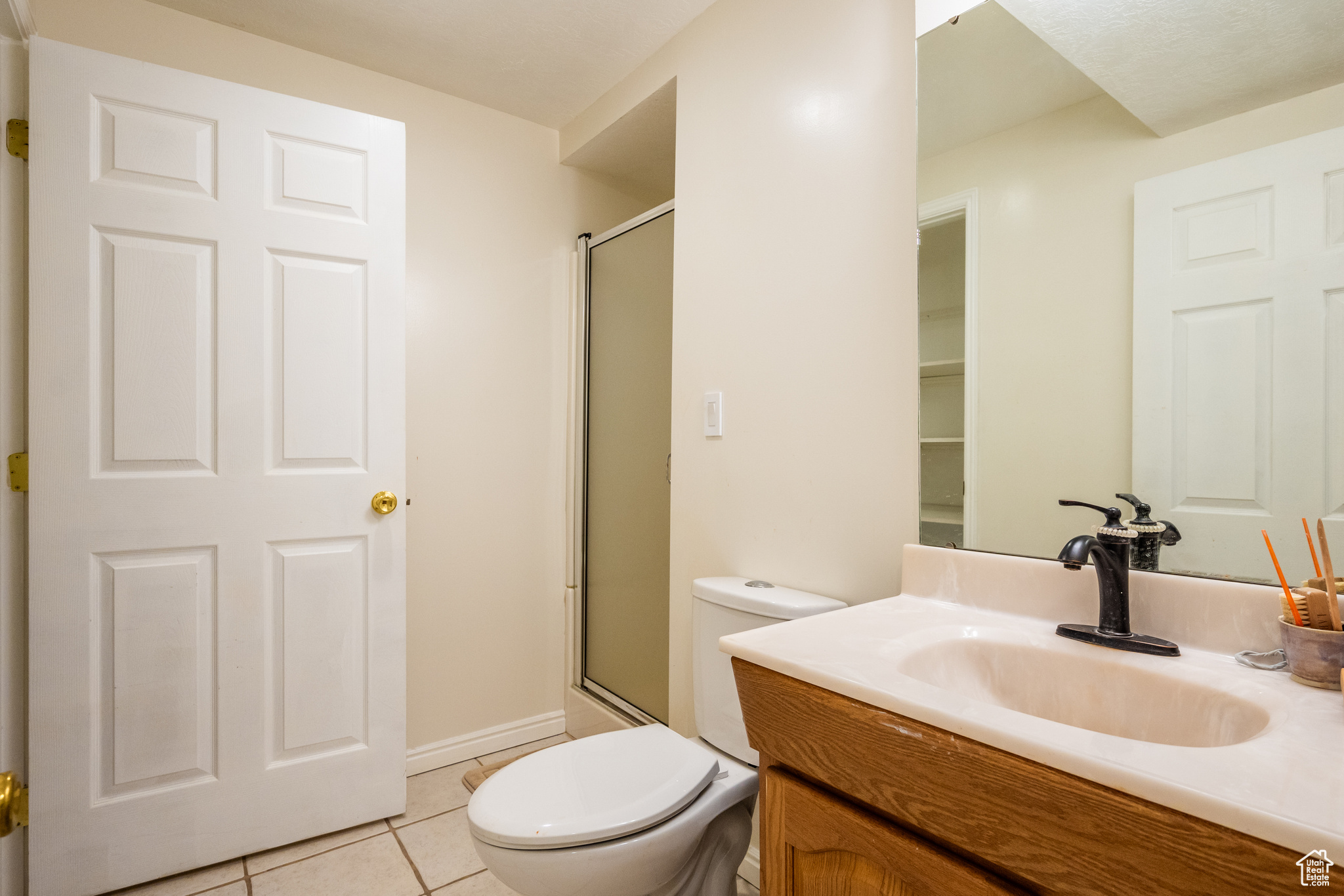 Bathroom featuring tile patterned floors, vanity, and toilet