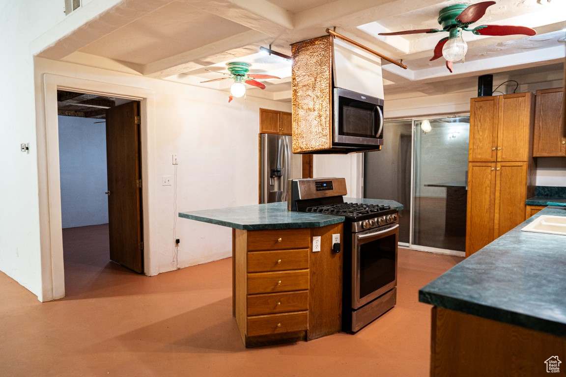 Kitchen featuring ceiling fan, sink, and stainless steel appliances