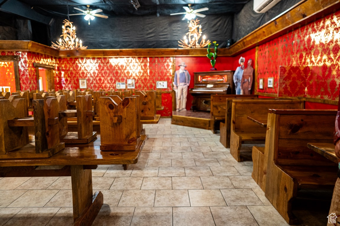 Bar with ceiling fan and tile patterned flooring