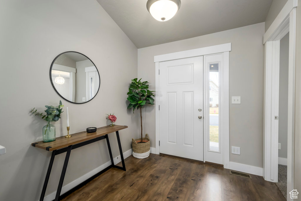 Entryway with dark hardwood / wood-style floors and lofted ceiling