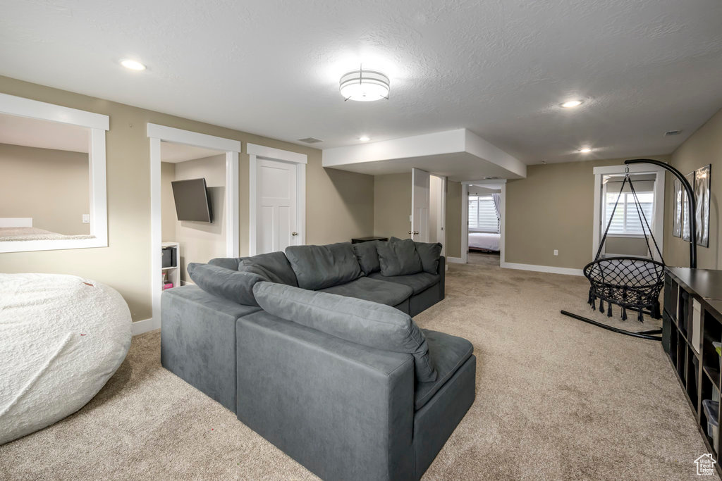 Carpeted living room featuring a textured ceiling