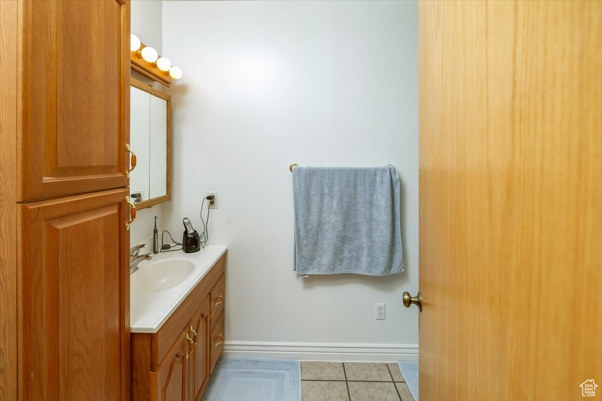 Bathroom with tile patterned flooring and vanity