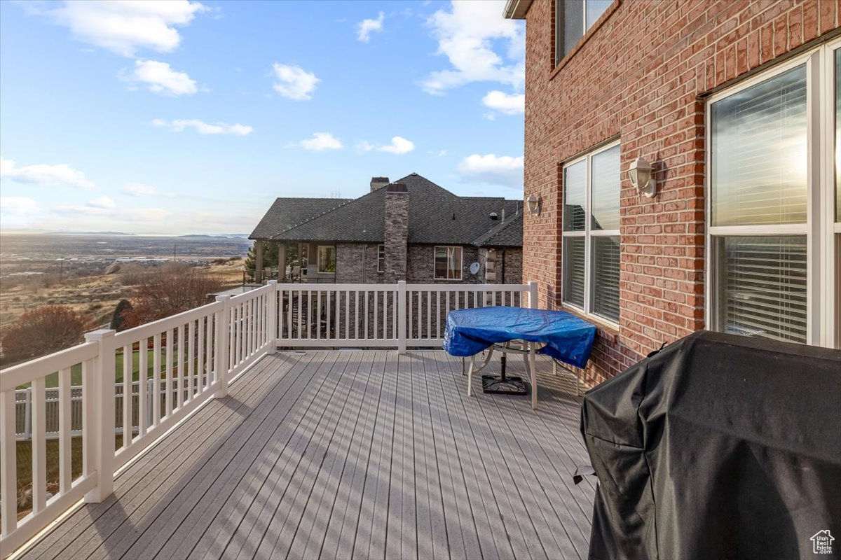 Wooden deck featuring area for grilling