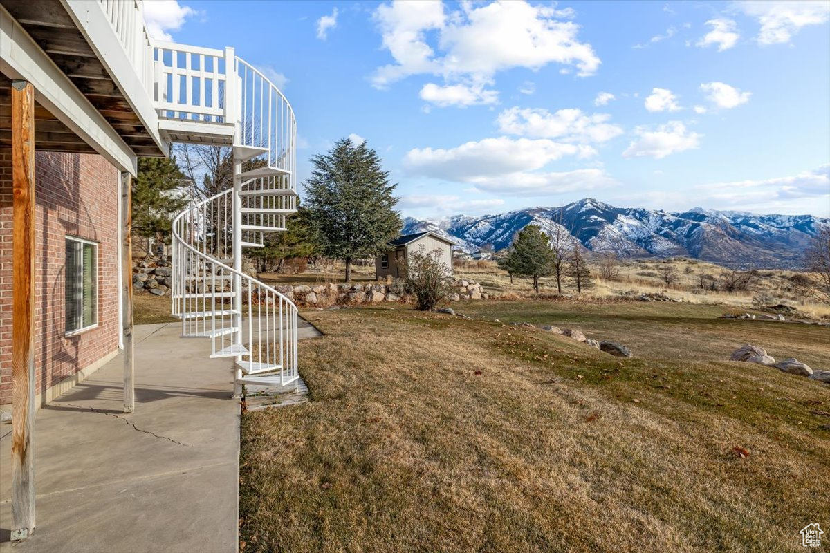 View of yard featuring a mountain view and a patio