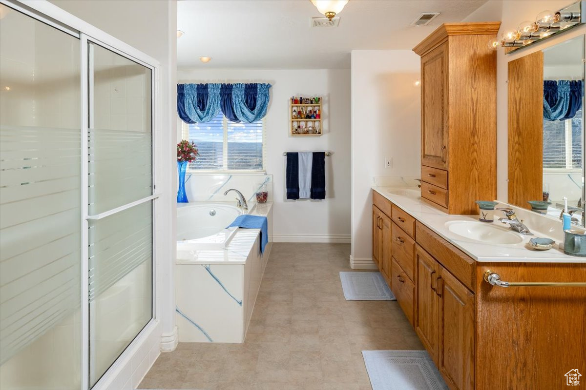 Bathroom with plus walk in shower and vanity