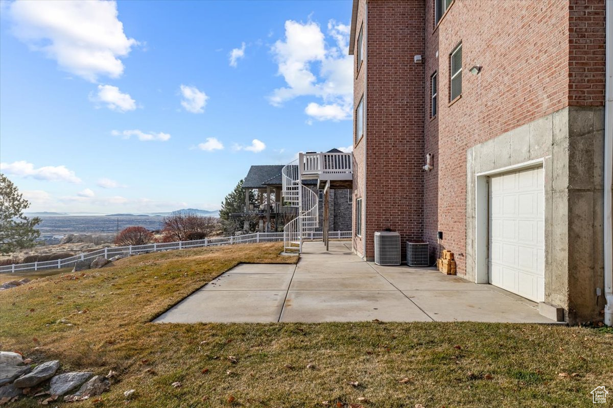 View of yard with a mountain view, a garage, and a patio area