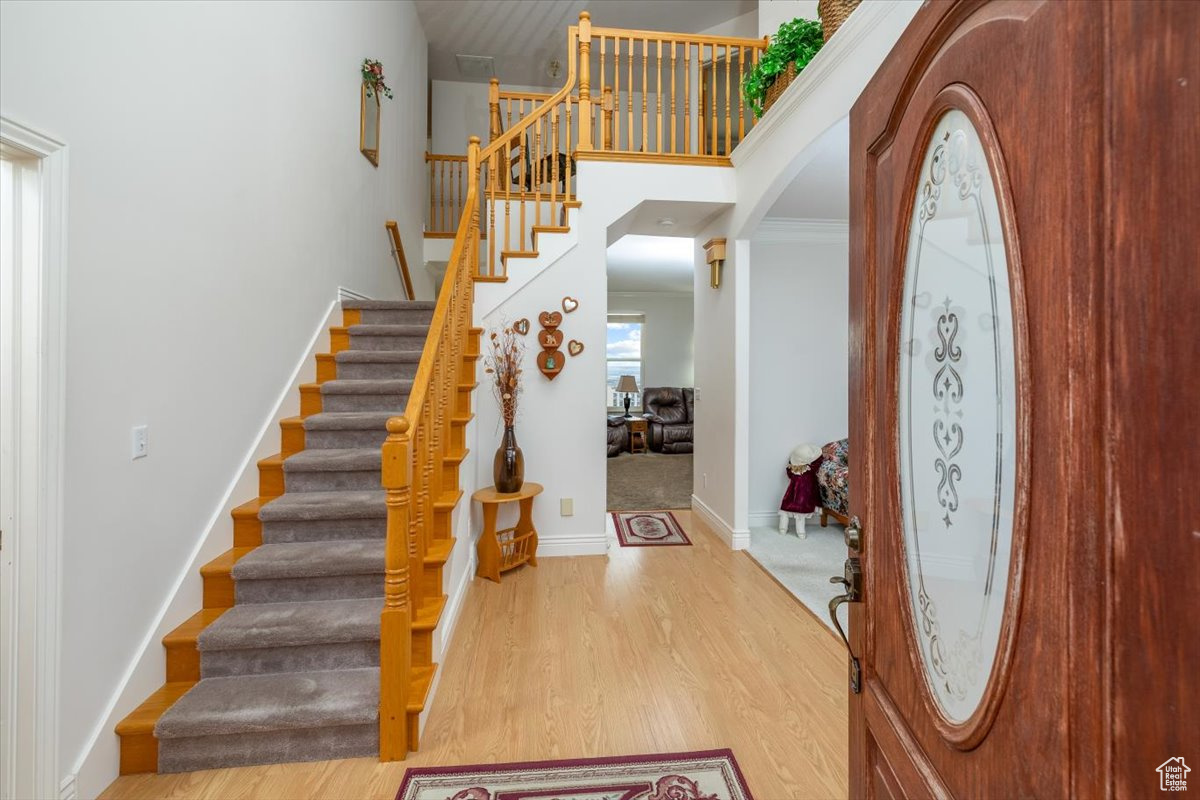 Entryway featuring wood-type flooring and ornamental molding