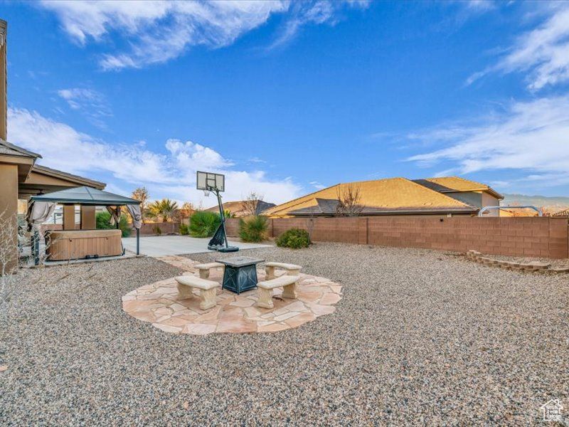 View of yard with a fire pit, a gazebo, a patio, and a hot tub