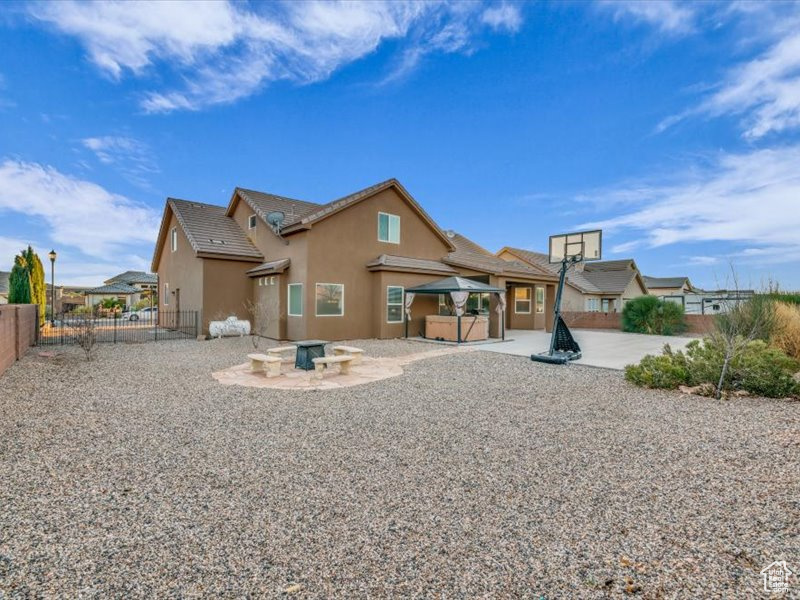 Rear view of house featuring a patio area and an outdoor fire pit