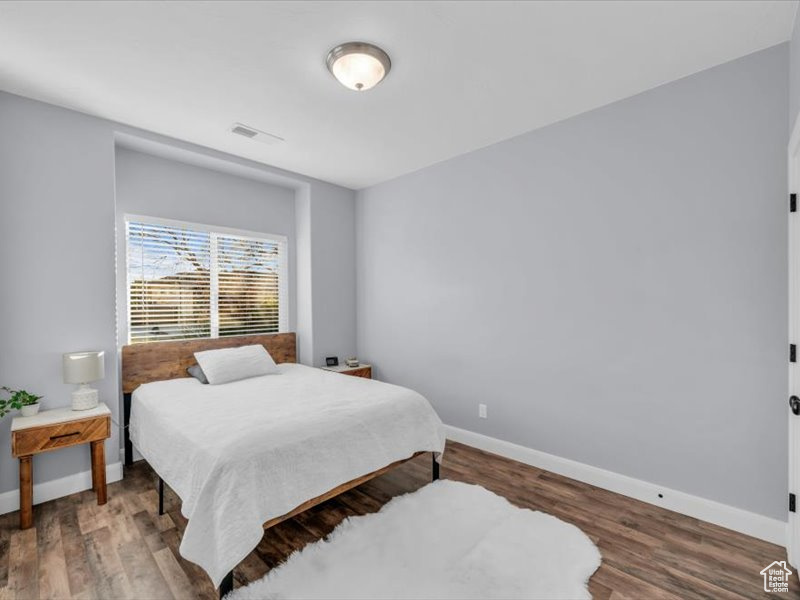 Bedroom with wood-type flooring