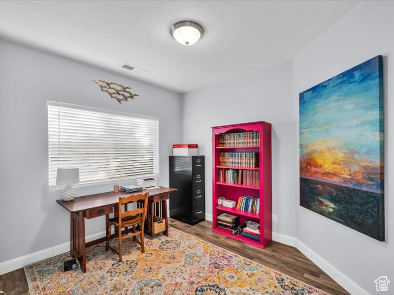 Office space with hardwood / wood-style floors