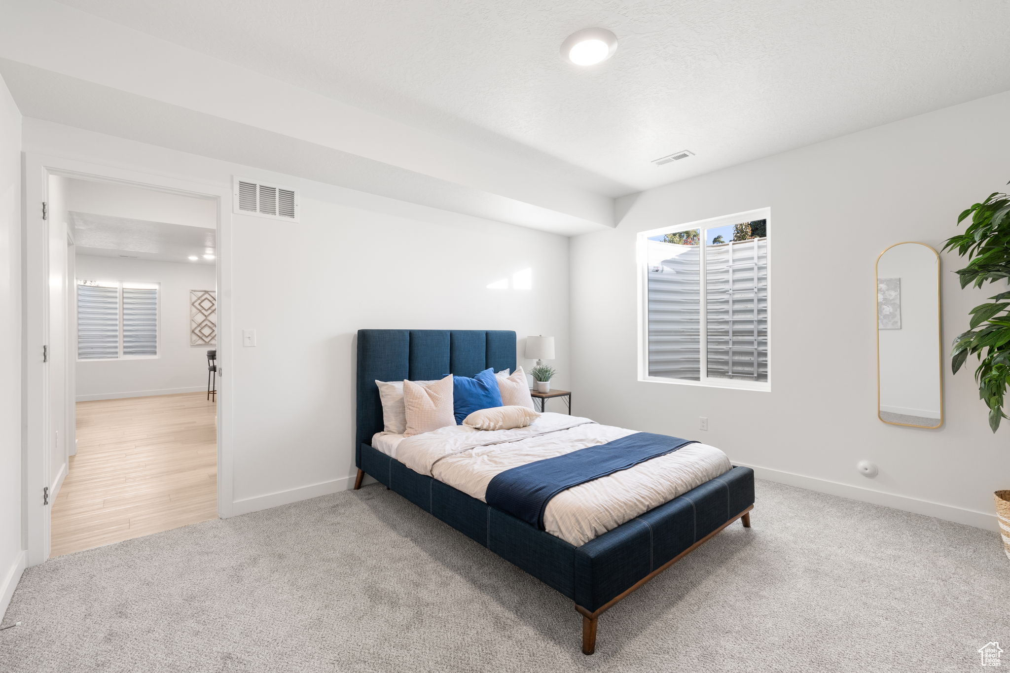 Bedroom with light colored carpet