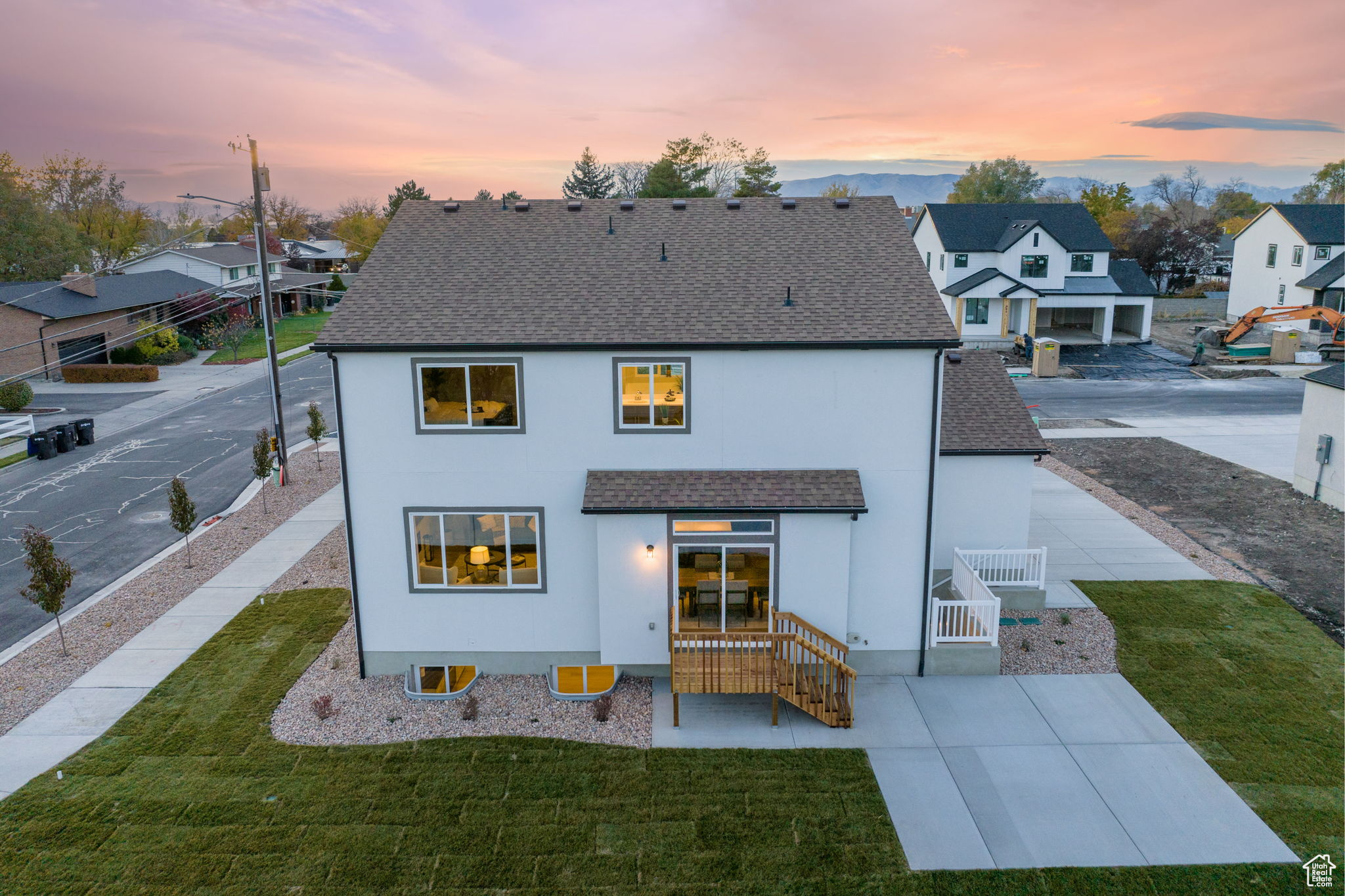 Back house at dusk with a yard