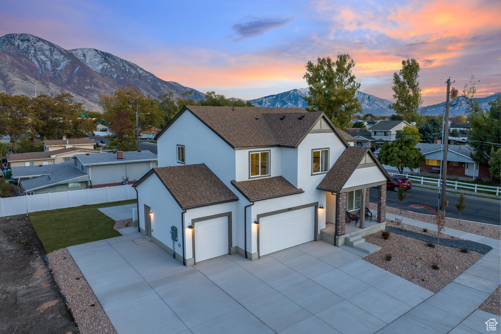 View of front of home with a mountain view, a yard, and a garage