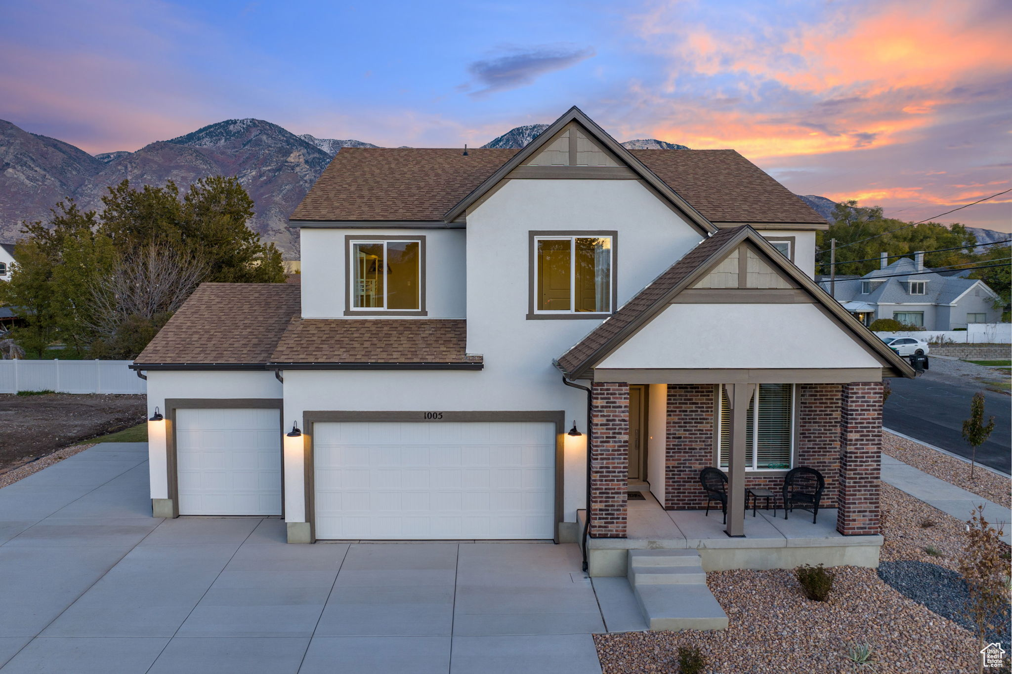 View of front of home with a mountain view, covered porch, and a garage