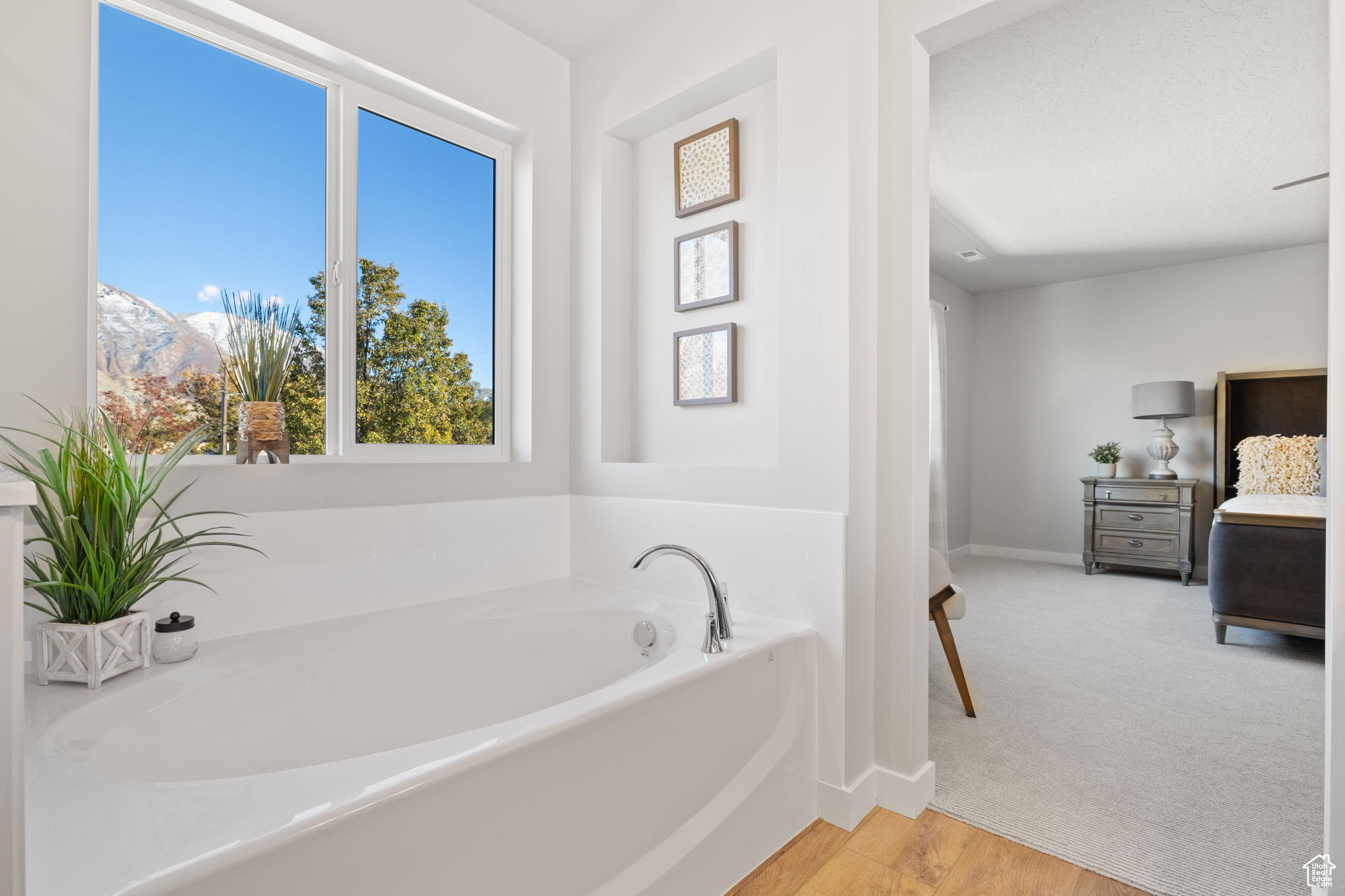 Bathroom featuring a mountain view, wood-type flooring, and a bathing tub