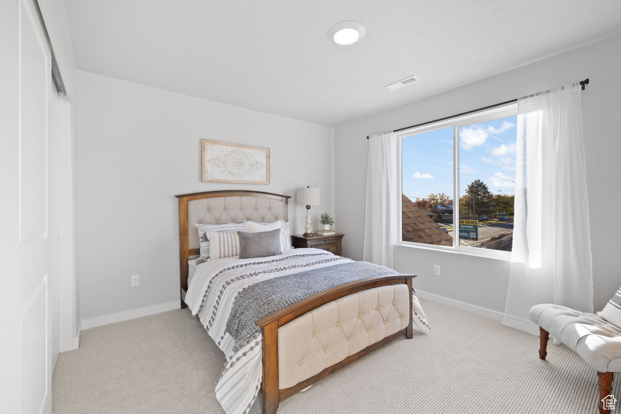 Bedroom with light carpet