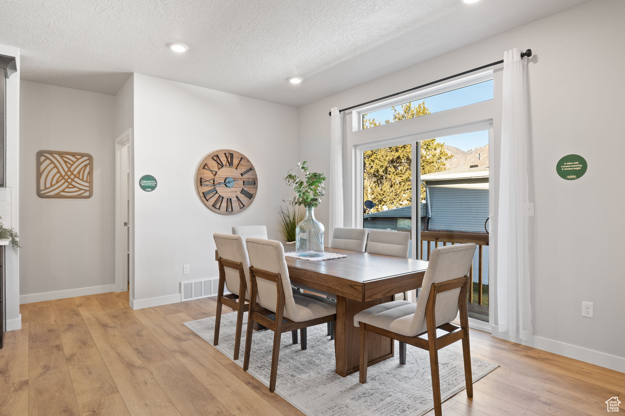 Dining area featuring a textured ceiling and light hardwood / wood-style flooring