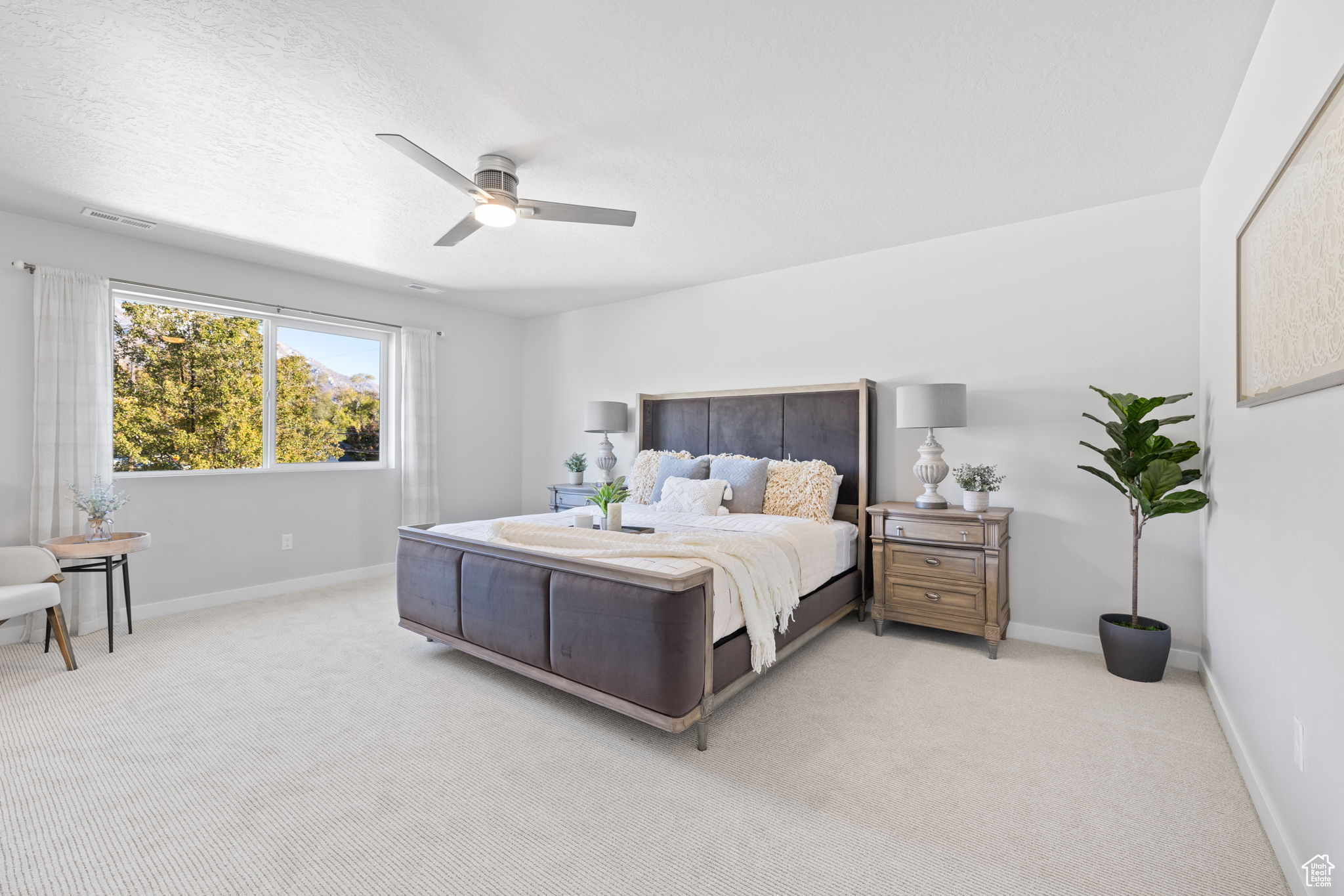 Bedroom with light carpet and ceiling fan