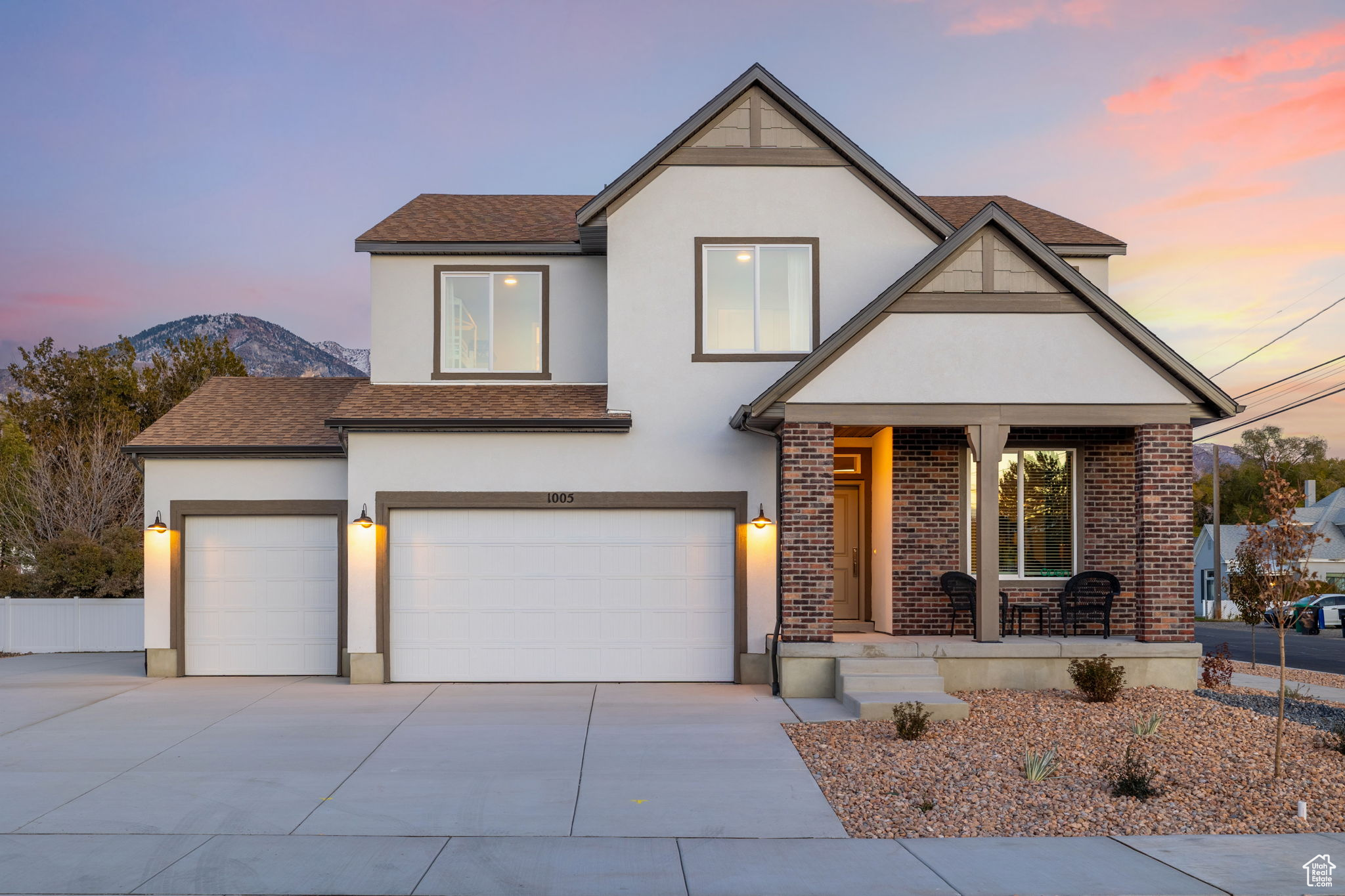 View of front facade with a mountain view, a porch, and a garage