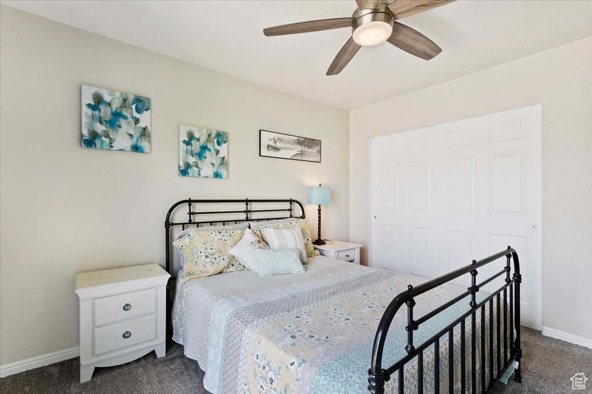 Carpeted bedroom with ceiling fan