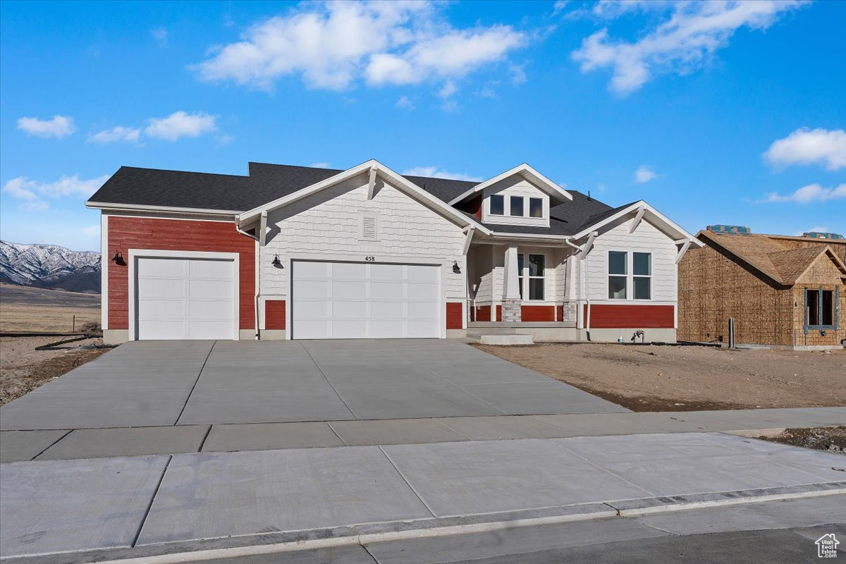 View of front of house featuring a mountain view and a 3-car garage