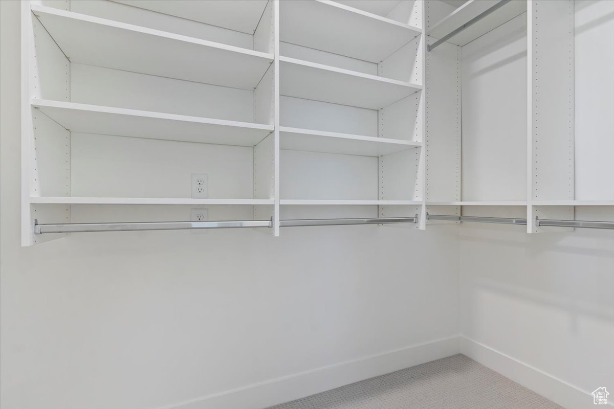 View of walk in closet with customizable shelving