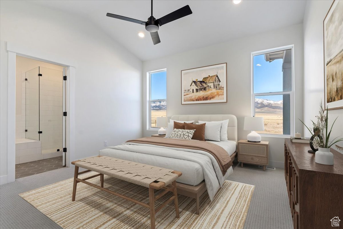 Primary bedroom with lofted ceiling, walk in closet and ensuite bathroom