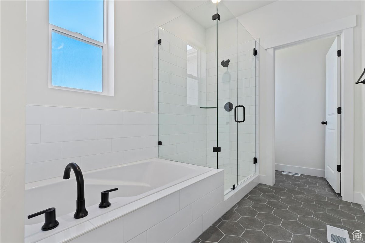 Bathroom with tile floors and separate euro-glass shower and tub