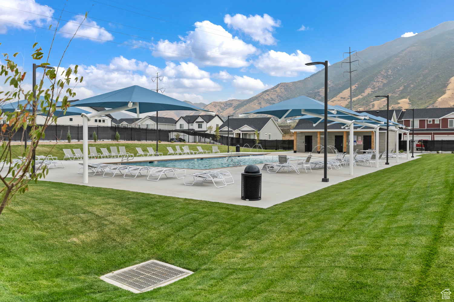 View of swimming pool featuring a mountain view, a patio, and a lawn