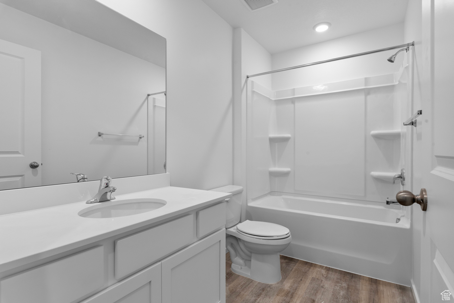 Full bathroom featuring LVP floors, vanity, toilet, and bathtub / shower combination