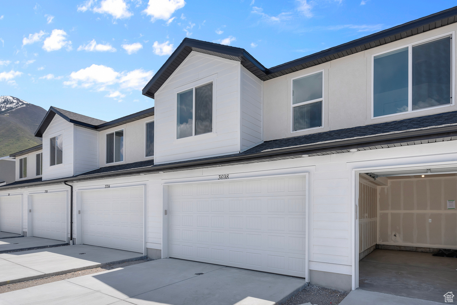 View of front of property with a mountain view and a garage