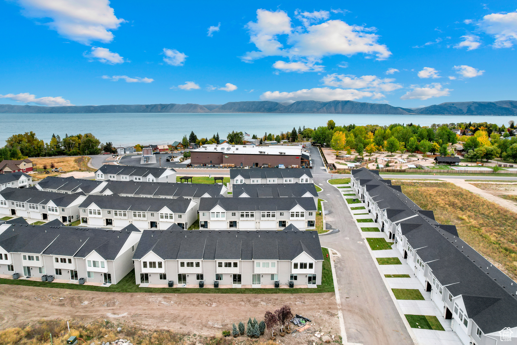 Birds eye view of property with a water and mountain view