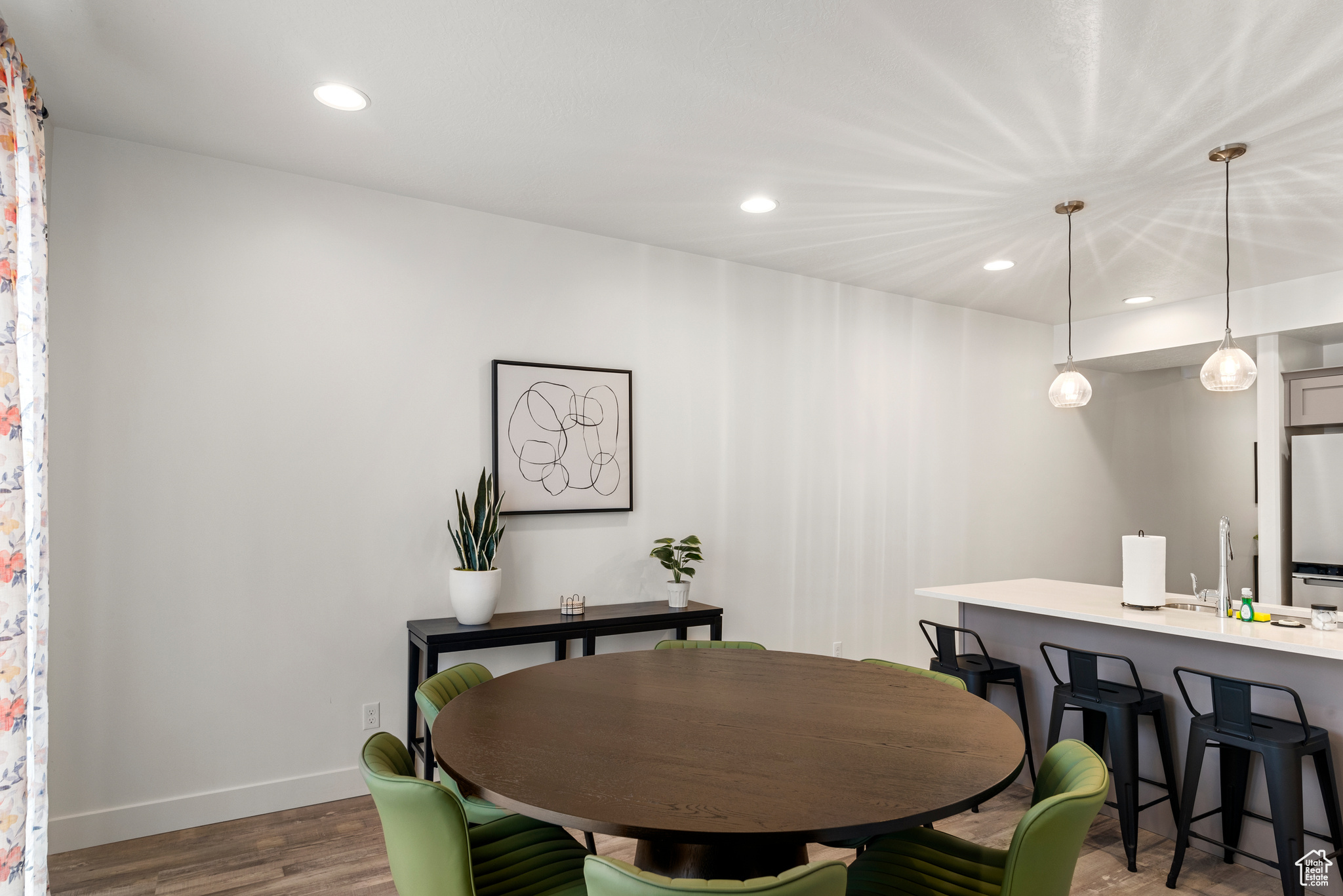 Dining space with wood-type flooring and sink