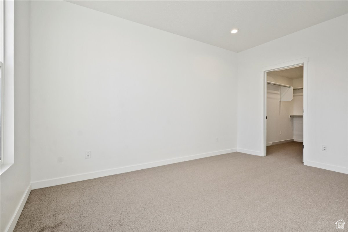 Empty room with light colored carpet