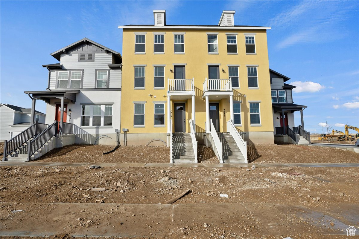 View of front of house featuring a balcony