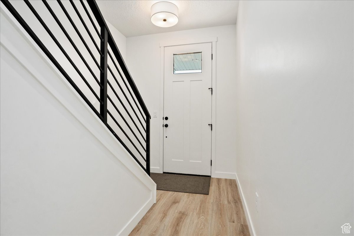 Entrance foyer featuring light hardwood / wood-style flooring