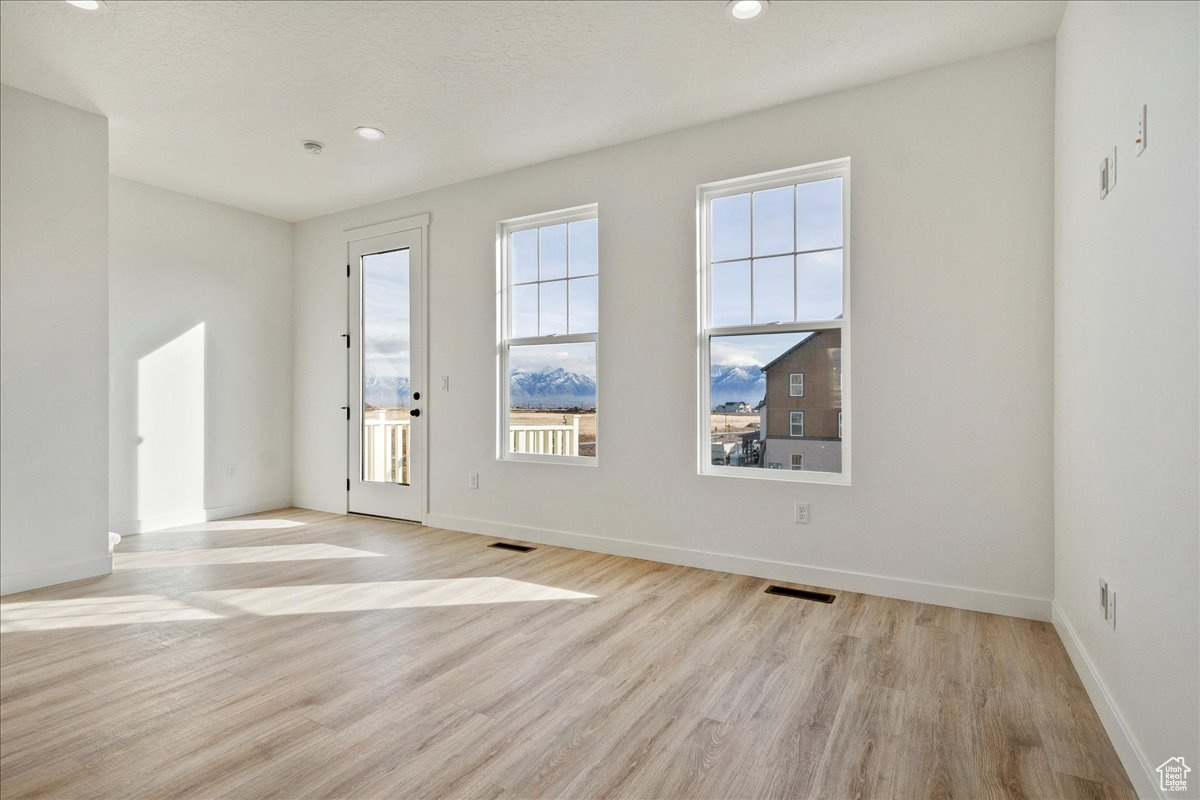 Empty room featuring light hardwood / wood-style flooring