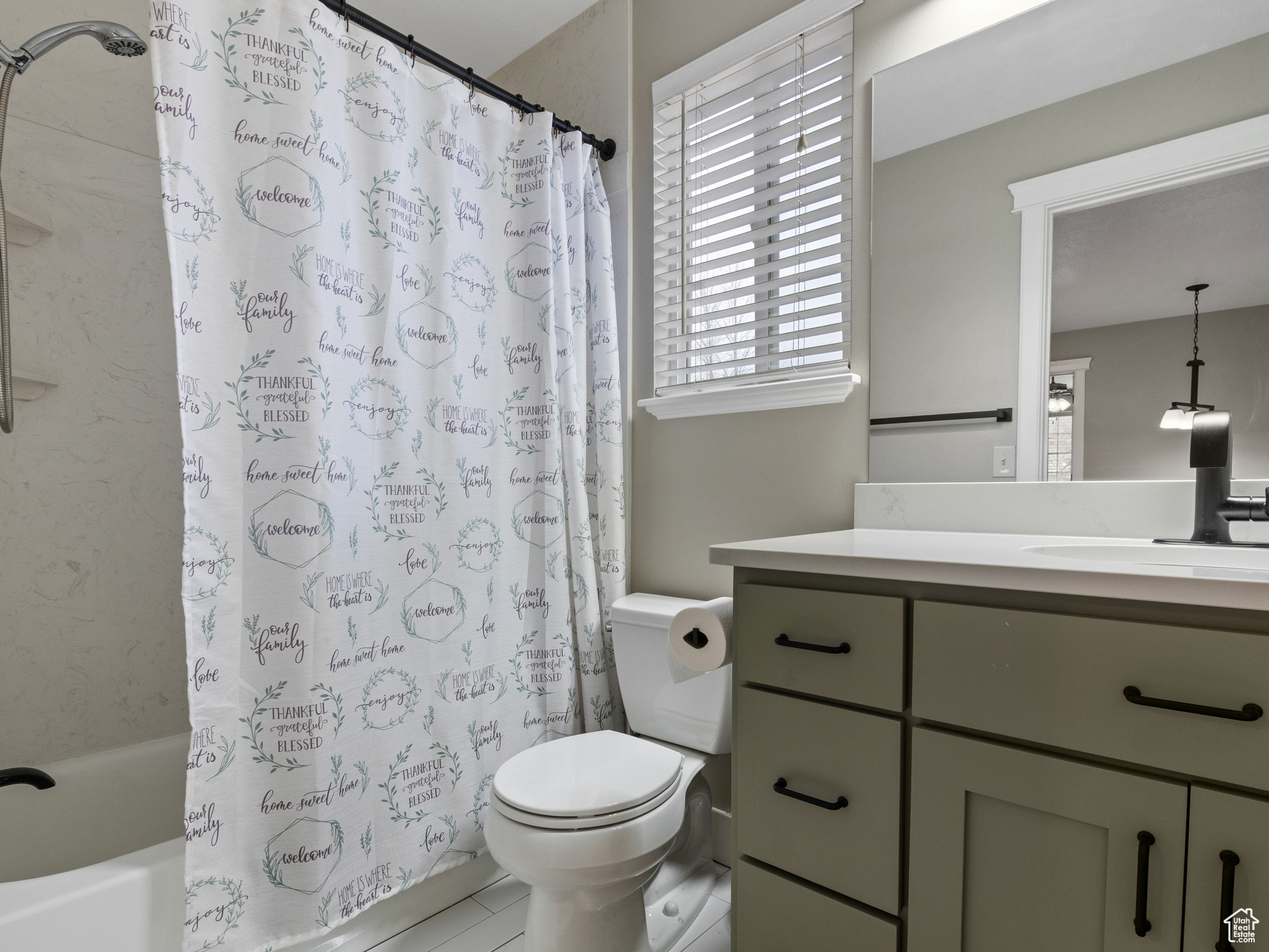 Full bathroom with vanity, toilet, and shower / bath combo with shower curtain