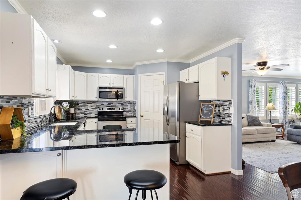 Main floor kitchen with large pantry, granite countertops and backsplash.