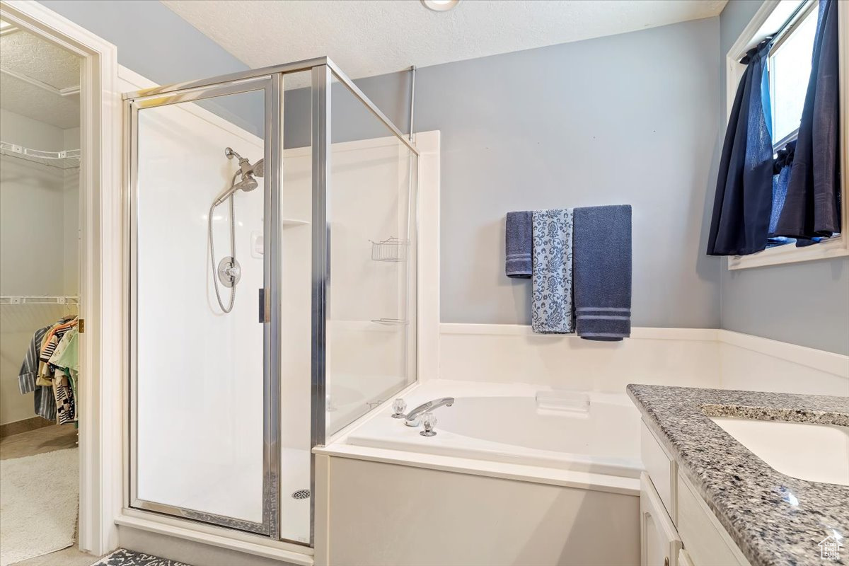 Large owner's bathroom with double vanity sink, corner tub and walk-in shower.