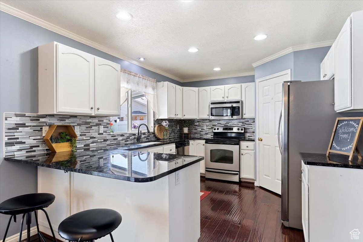 Main floor kitchen with large pantry, granite countertops and backsplash.